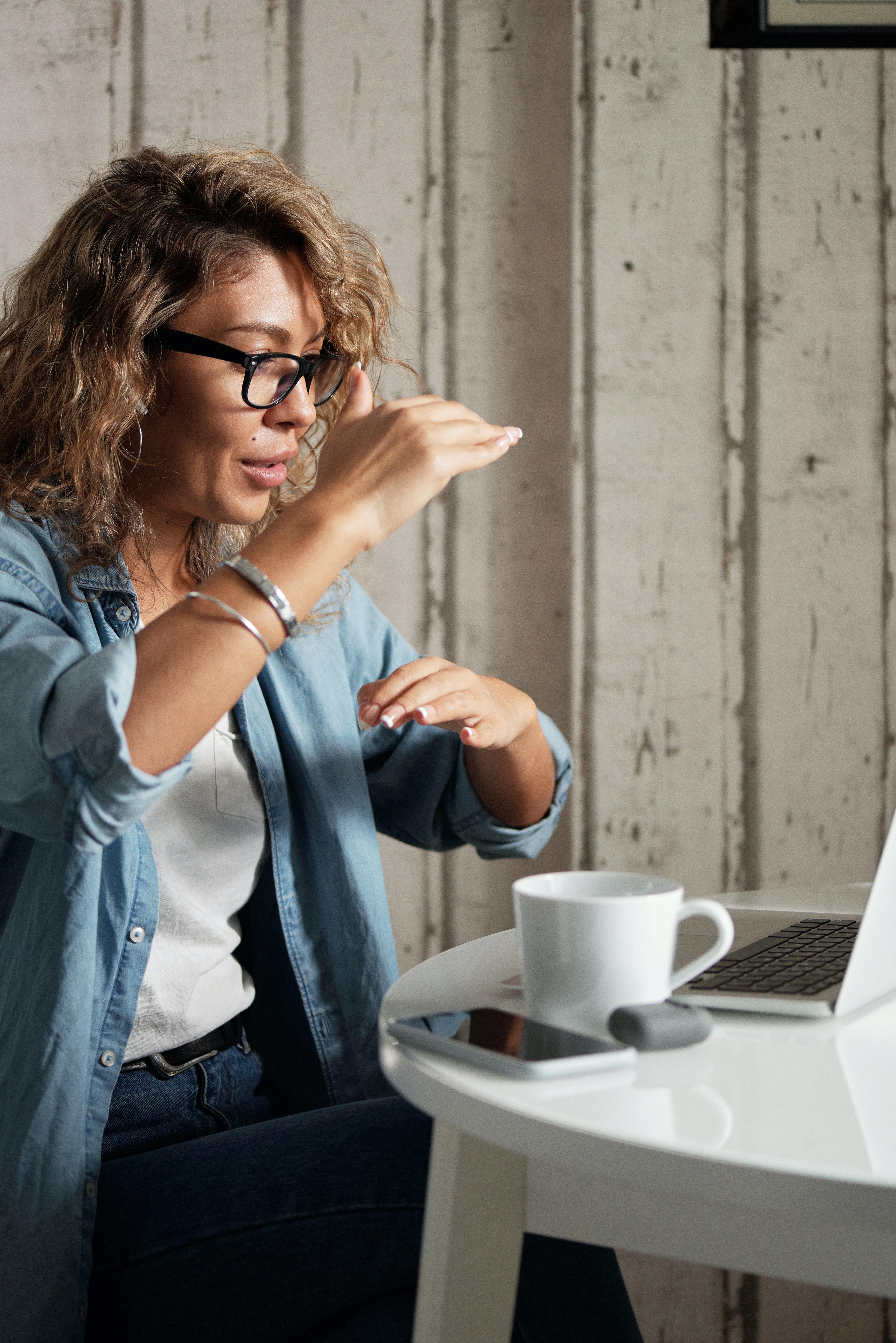 Woman leading a meeting from her laptop.